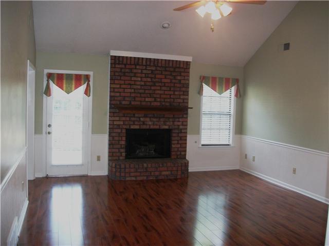 6913 Andrews Road Bartlett, TN 38135 - Photo 4 of 18 Charming Living Room with fireplace and door opening to spacious wooded deck.