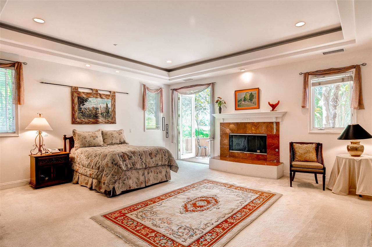 14888 Las Mananas Rancho Santa Fe, CA 92067 - Photo 20 of 25 This magnificent master bedroom is spacious yet cozy with a fireplace, french doors and a patio. You will also enjoy the large his and hers closets.