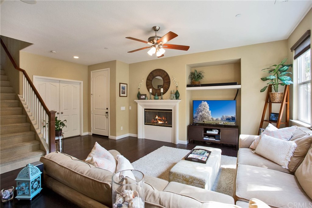21 Corte Javier San Clemente, CA 92673 - Photo 7 of 30 The family room is warm and inviting with a cozy fireplace, lighted ceiling fan, and warm toned hardwood floors.