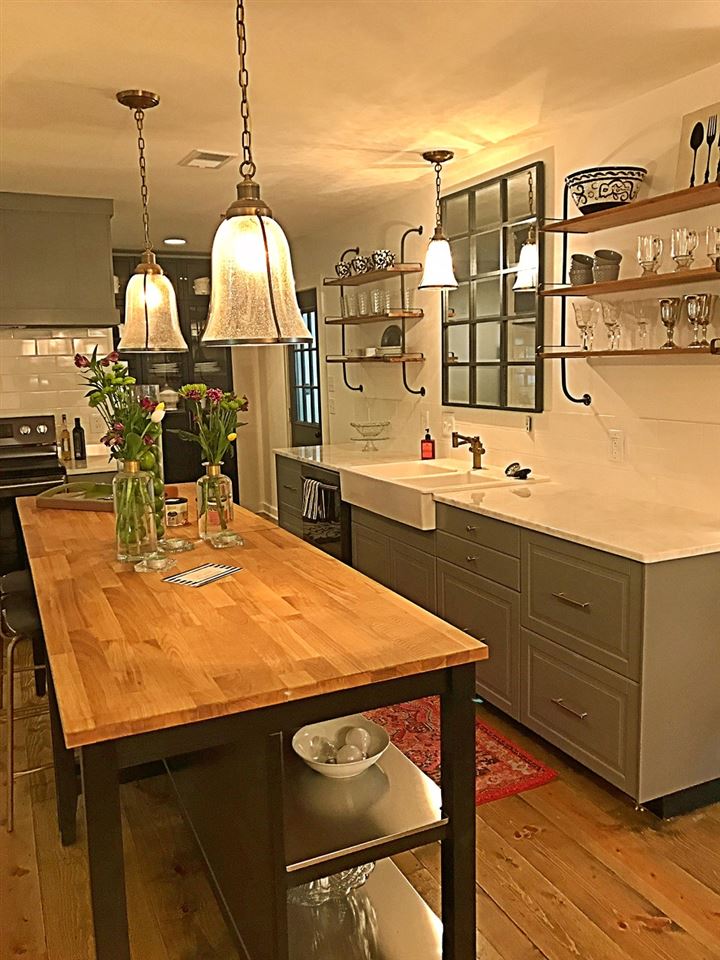 Extra long island is perfect for dining and is a great prep area!  Open Shelving and subway tile create a very modern look.