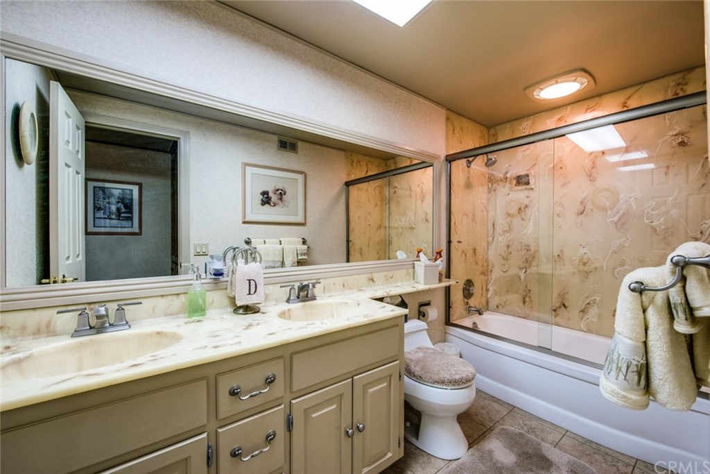 2001 Cypress Point Drive Corona, CA 92882 - Photo 40 of 62 Upstairs guest bathroom with dual sinks and enclosed bathtub/shower