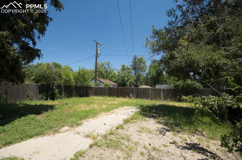 615 Sunset Road Colorado Springs, CO 80909 - Photo 14 of 20 Large fenced in backyard would be ideal for a garden.