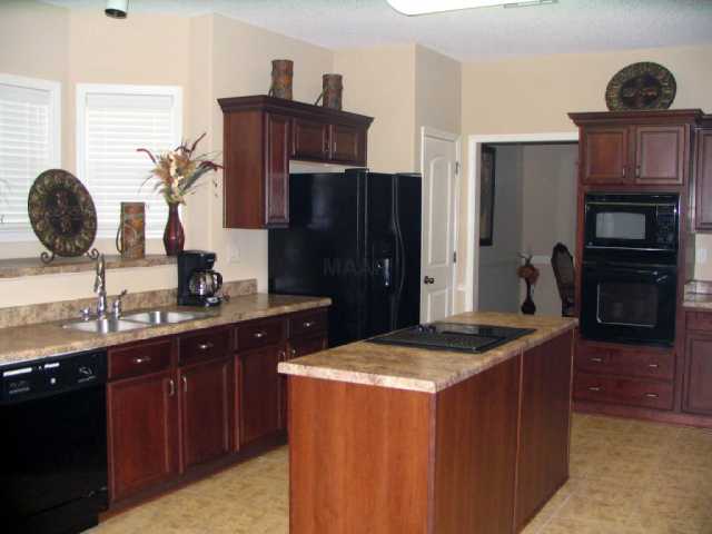 8515 Boothes Ridge Drive Memphis, TN 38125 - Photo 7 of 12 Gourmet Kitchen with cooktop island. Cooktop has a built-in grill w/ downdraft which is vented outside.