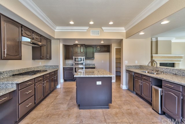 3086 Diamondview Circle Corona, CA 92882 - Photo 8 of 66 The expansive central kitchen with a preparation island, a large walk-in pantry, a breakfast nook and a large breakfast bar is the hub of this home. It has brand new granite counter tops with dual sinks, stainless steel appliances, including a brand new microwave and oven, retained cabinetry, crown moldings and recessed lighting.