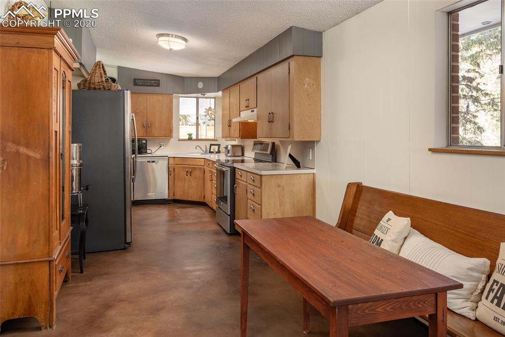 8715 Chipita Park Road Cascade, CO 80809 - Photo 16 of 33 Kitchen view from the main room. Durable stained concrete floors.
