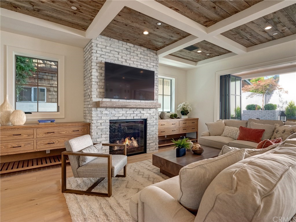 559 31st Street Manhattan Beach, CA 90266 - Photo 4 of 49 65" TV already installed, gas fireplace, Trestlewood reclaimed wood ceiling accents, white oak flooring, LaCantina door systems, built-in cabinetry, white washed brick fireplace, recessed lighting, whole home surround sound.