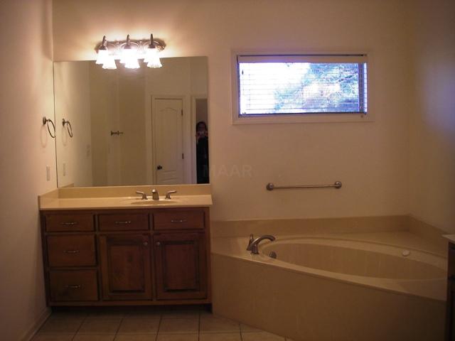 4361 Airline Road Arlington, TN 38002 - Photo 8 of 12 Master Bath/spa has separate bath/shower with his/her sinks. Tiled floor.