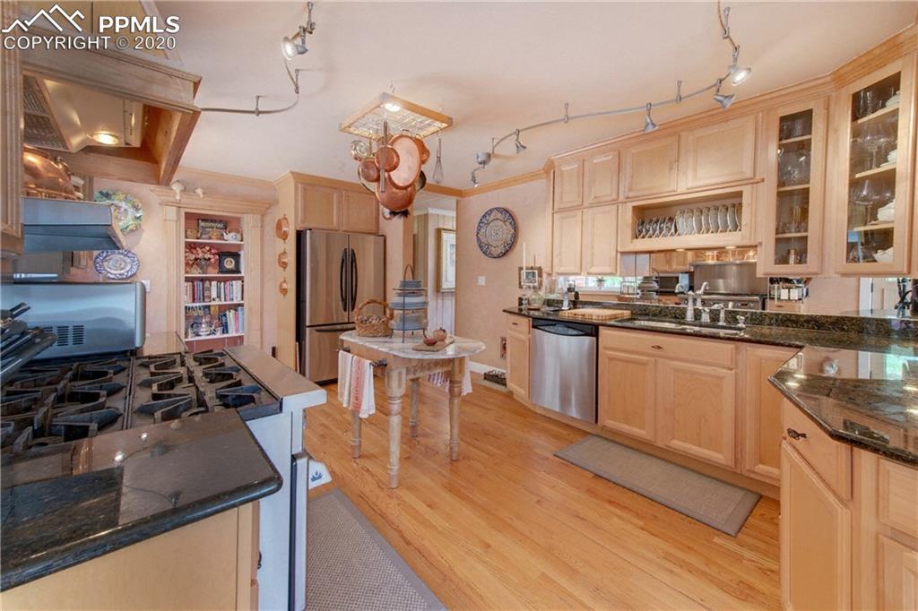 7955 Highway 24 Cascade, CO 80809 - Photo 10 of 36 Gourmet kitchen offers maple cabinetry and striking black granite counter tops.