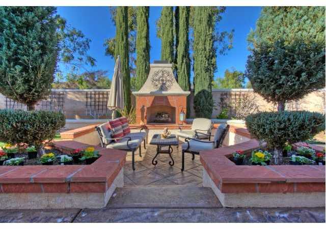 12390 Mesa Crest Road Poway, CA 92064 - Photo 22 of 25 Step out to your BEAUTIFUL backyard to relax at the gas fireplace.