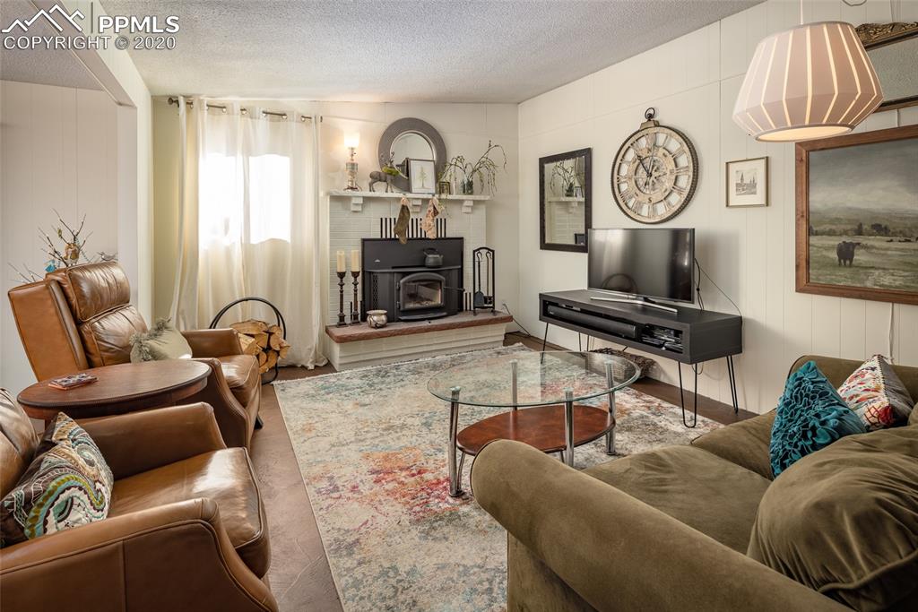 8715 Chipita Park Road Cascade, CO 80809 - Photo 13 of 33 Nicely updated brick fireplace with insert in the front room. This fireplace provides excellent secondary heating for the home.