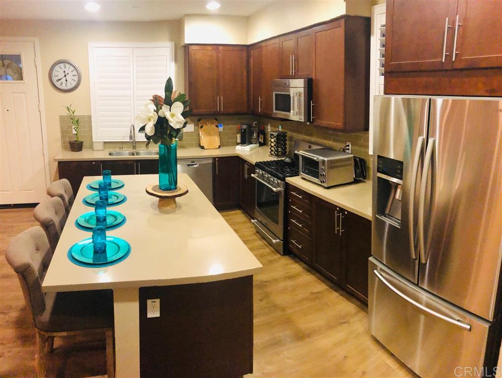 17 Alzada Street Rancho Mission Viejo, CA 92694 - Photo 6 of 20 Stainless steel appliances and sink, backsplash, upgraded stained shaker cabinets