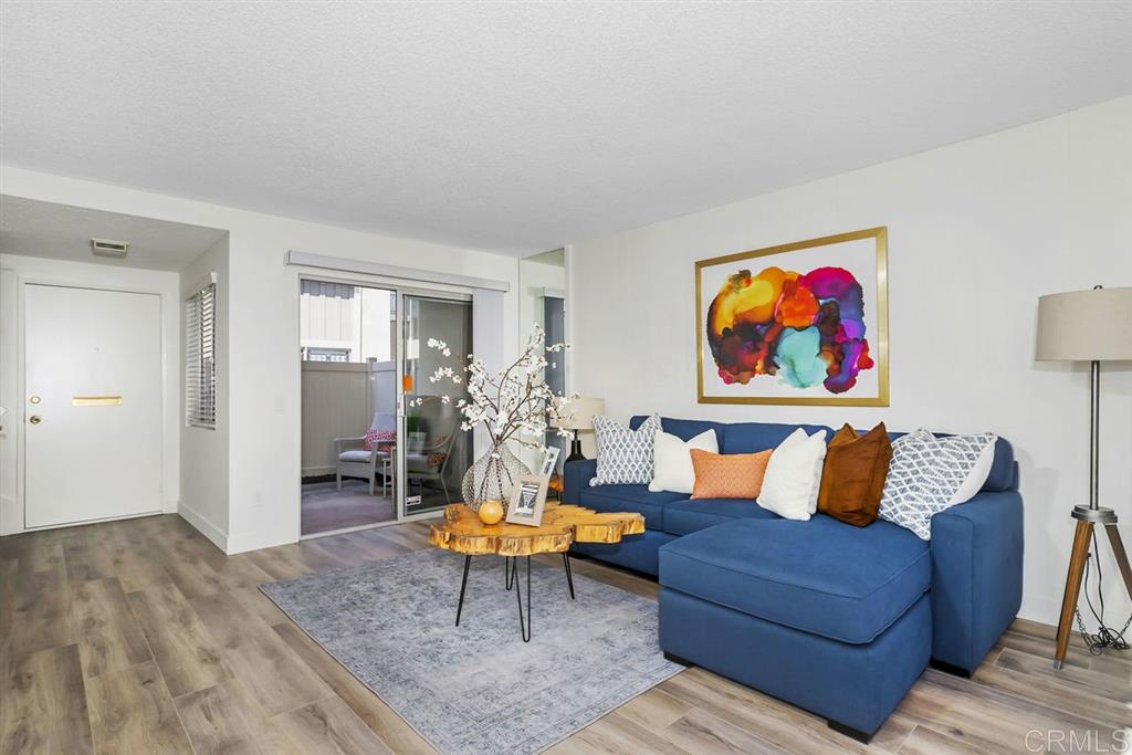7855 Hummingbird Lane San Diego, CA 92123 - Photo 3 of 25 Beautiful and bright living room with 2 patios for exceptional indoor/outdoor living.