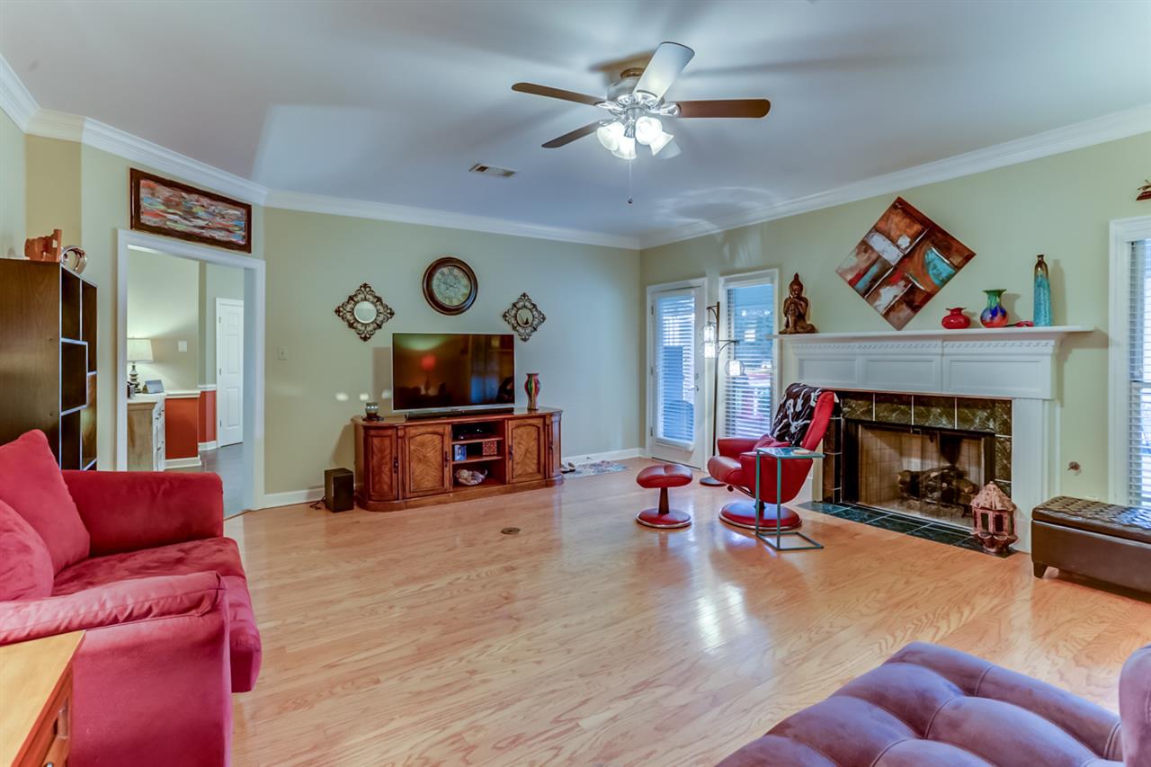 6846 Tree Spring Cove Bartlett, TN 38135 - Photo 5 of 25 The spacious great room is the perfect place to entertain and relax. This room features gleaming wood floors, crown molding, a cooling ceiling fan, and a cozy fireplace perfect for those cozy nights at home.
