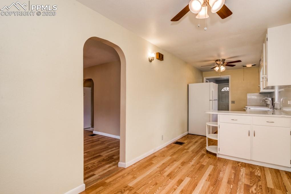 611 Prairie Road Colorado Springs, CO 80909 - Photo 5 of 18 The dining room keeps you close to both the kitchen and living room area.