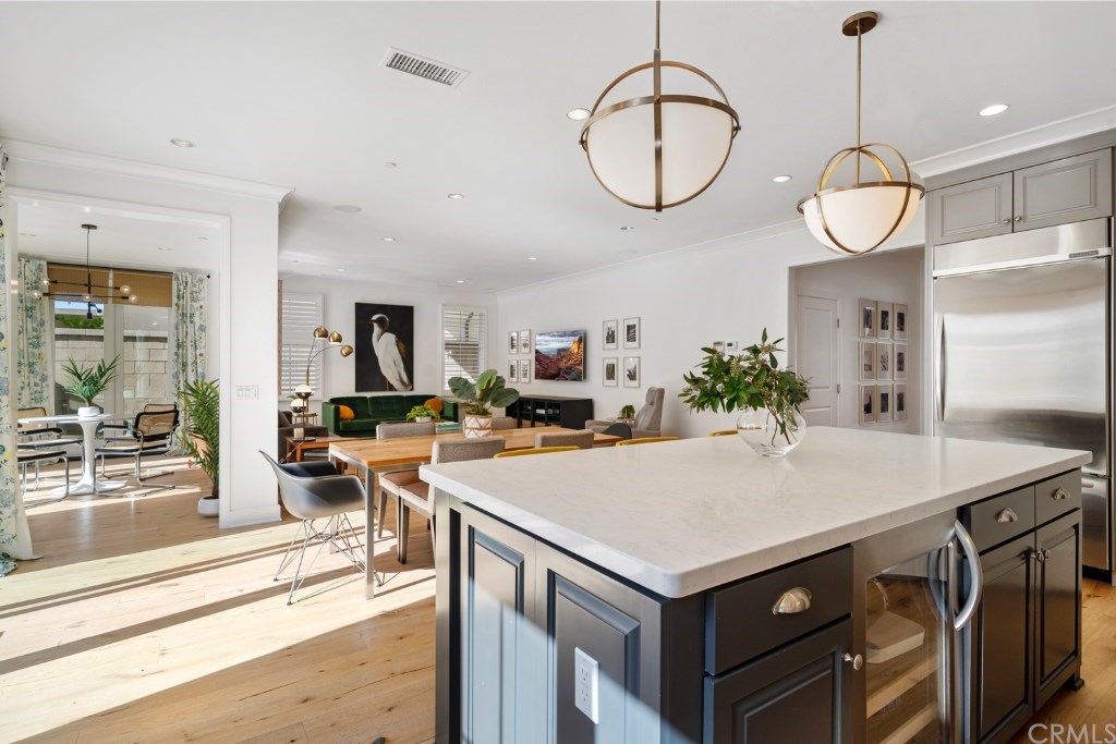 116 Mosswood Irvine, CA 92620 - Photo 42 of 42 A view of the open floor plan from the kitchen. The main living area faces south, which allow abundant natural light to flood the great kitchen, great room, dining area and conservatory room.