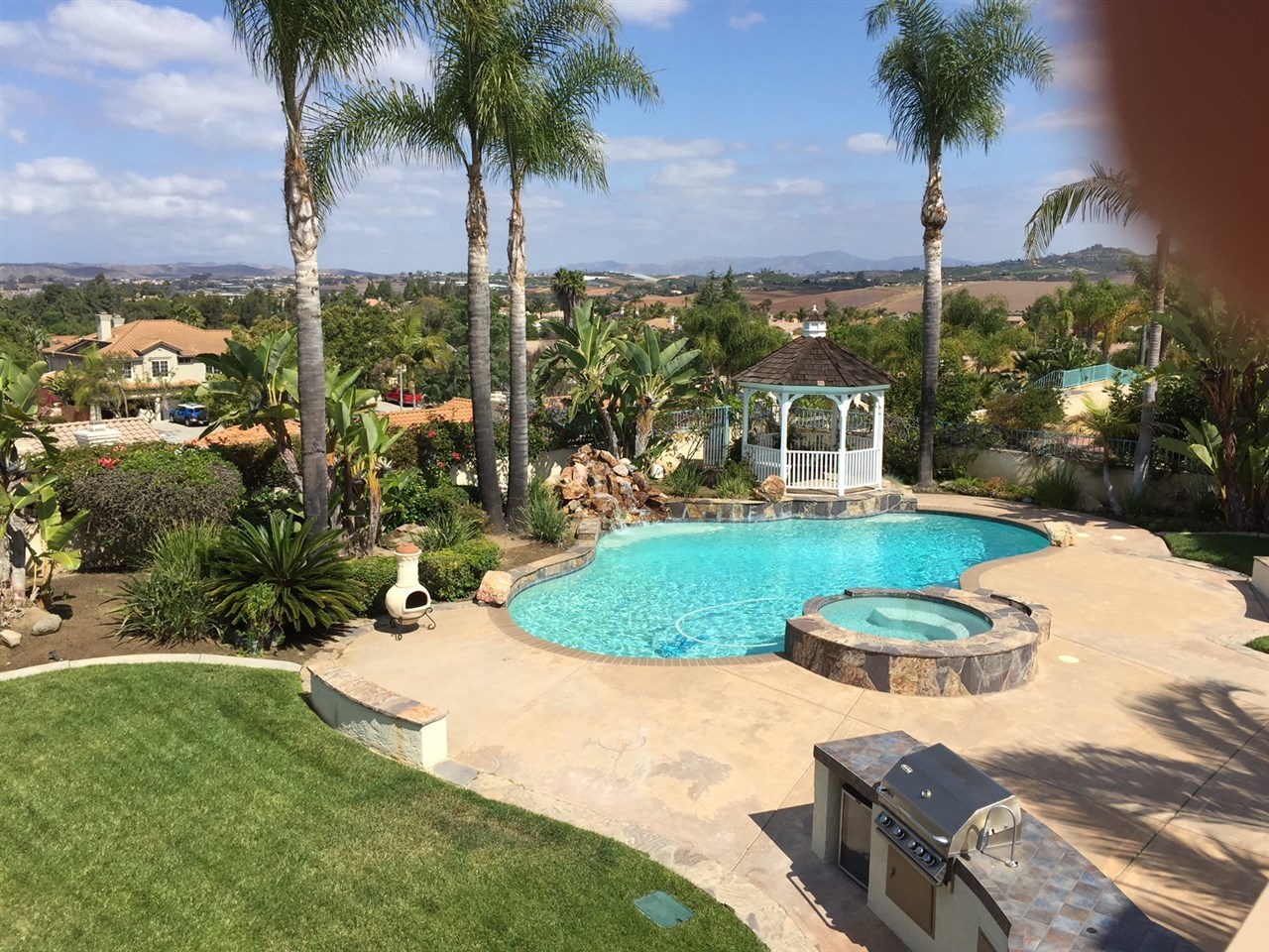 1657 Del Mar Road Oceanside, CA 92057 - Photo 1 of 19 Tropical paradise with views to Big Bear, surrounding hillsides, Sleeping Indian & a peek of the Ocean on a clear day. Pool & spa are saltwater with a rock waterfall, gazebo & a BBQ Island