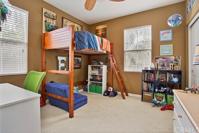 21 Corte Javier San Clemente, CA 92673 - Photo 19 of 30 Bedroom 2 is spacious with lighted ceiling fan, wood blinds and neutral toned carpeting.