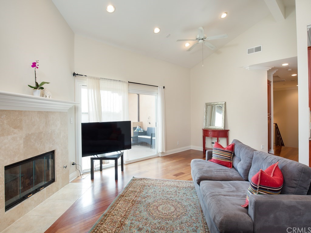 2302 Grant Avenue, Unit 2 Redondo Beach, CA 90278 - Photo 10 of 29 Living room welcomes a stylish fireplace with vaulted ceilings and recessed lighting.