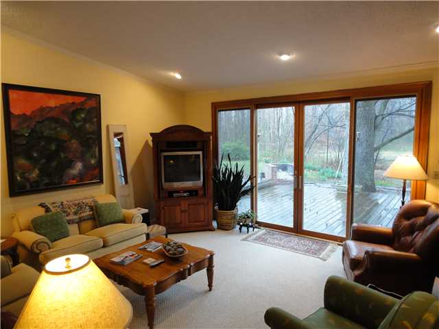 3014 Sycamore View Road Bartlett, TN 38134 - Photo 5 of 12 The den is in the newer part of the house. Pella doors open to the upper deck, and the handsome descent to the pool and gazebo --all overlooking the beginning of the naturalized terrain of the back of the estate. Fireplace out of view, on right.