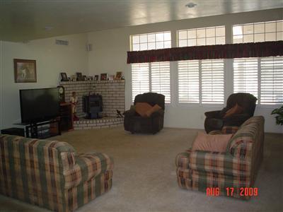 6937 Lindsay Road Bakersfield, CA 93313 - Photo 3 of 15 Dbl door tile entry steps down into the huge living rm. with a wall of windows with plantation shutters. Lovely view of backyard and property.