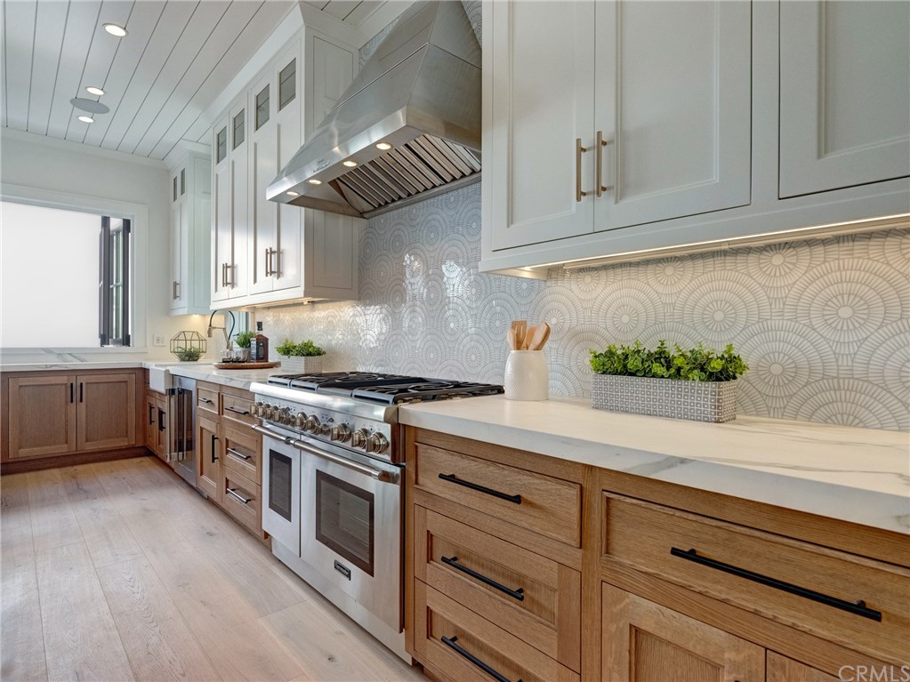 559 31st Street Manhattan Beach, CA 90266 - Photo 8 of 49 Neolith stone counters, Thermador professional series appliances, dual sinks, additional beverage fridge, Brizo faucets, breakfast counter, indoor/outdoor bar & entertainment area.