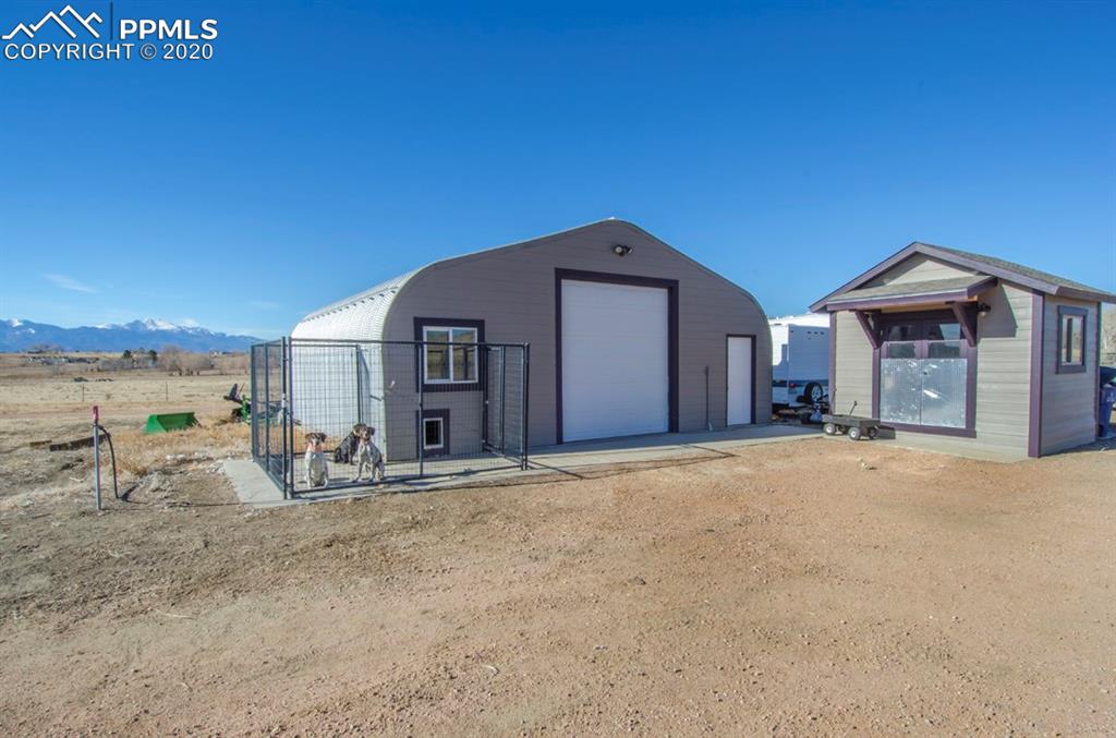 3235 South Meridian Road Colorado Springs, CO 80929 - Photo 6 of 36 Very nice 30x30 shop/garage with dog kennel. Fully insulated shed next to it with electricity.