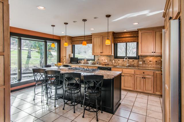 1108 Natchez Road Franklin, TN 37069 - Photo 4 of 25 Many family memories to be made in the main gathering room of the home - the kitchen. Elegant renovation features huge granite island with bar seating and 6 burner gas grill.