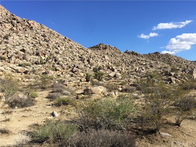 8140 Skyline Drive Joshua Tree, CA 92252 - Photo 9 of 27 The center of the five acres offers several building locations for future use. The property view to the east is up into the rocky hills.