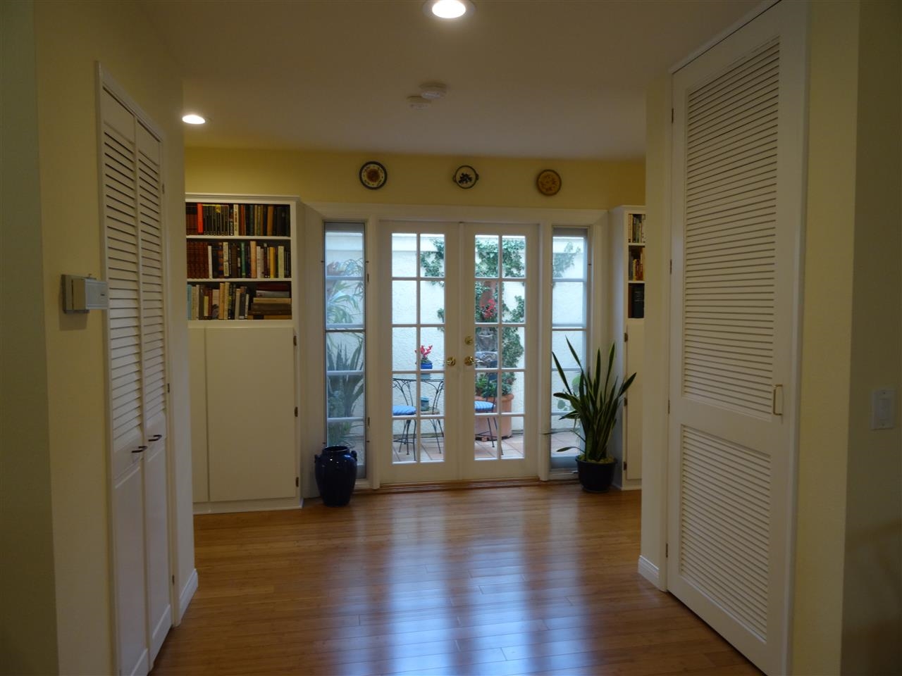13312 Pantera Road San Diego, CA 92130 - Photo 3 of 25 Hallway with built-ins, Recessed lighting, & French doors open onto private patio.