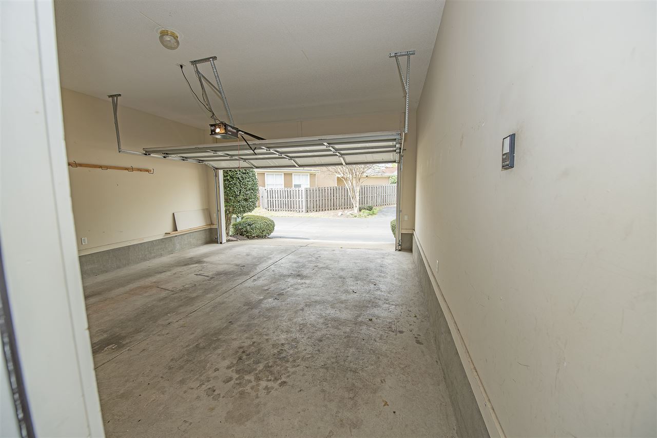 1237 Misty Isle Drive Memphis, TN 38103 - Photo 17 of 22 spacious two car garage. No home directly behind you so it's easy to park. There is a small community green area and extra parking spaces behind the home. Great for guest parking.