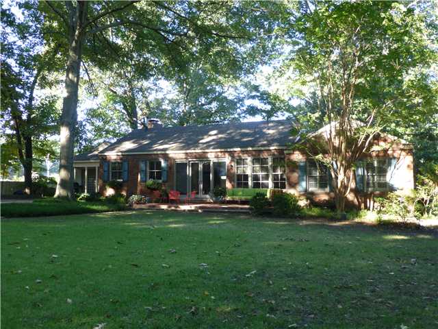 556 Cherry Road Memphis, TN 38117 - Photo 22 of 23 back of home with wide brick terrace framed by lovely trees and landscaping completes this lovelly setting