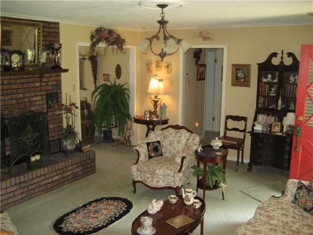 6025 McKinstry Road Moscow, TN 38057 - Photo 7 of 12 Other photo of living room, 2 cased openings to wonderful sunroom that opens to huge covered wood deck.