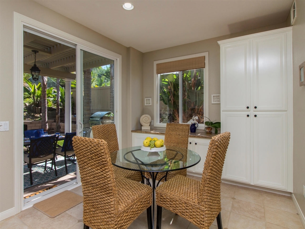 1267 Mariposa Road Carlsbad, CA 92011 - Photo 7 of 25 Sliding glass doors lead out from the kitchen to the shaded patio!