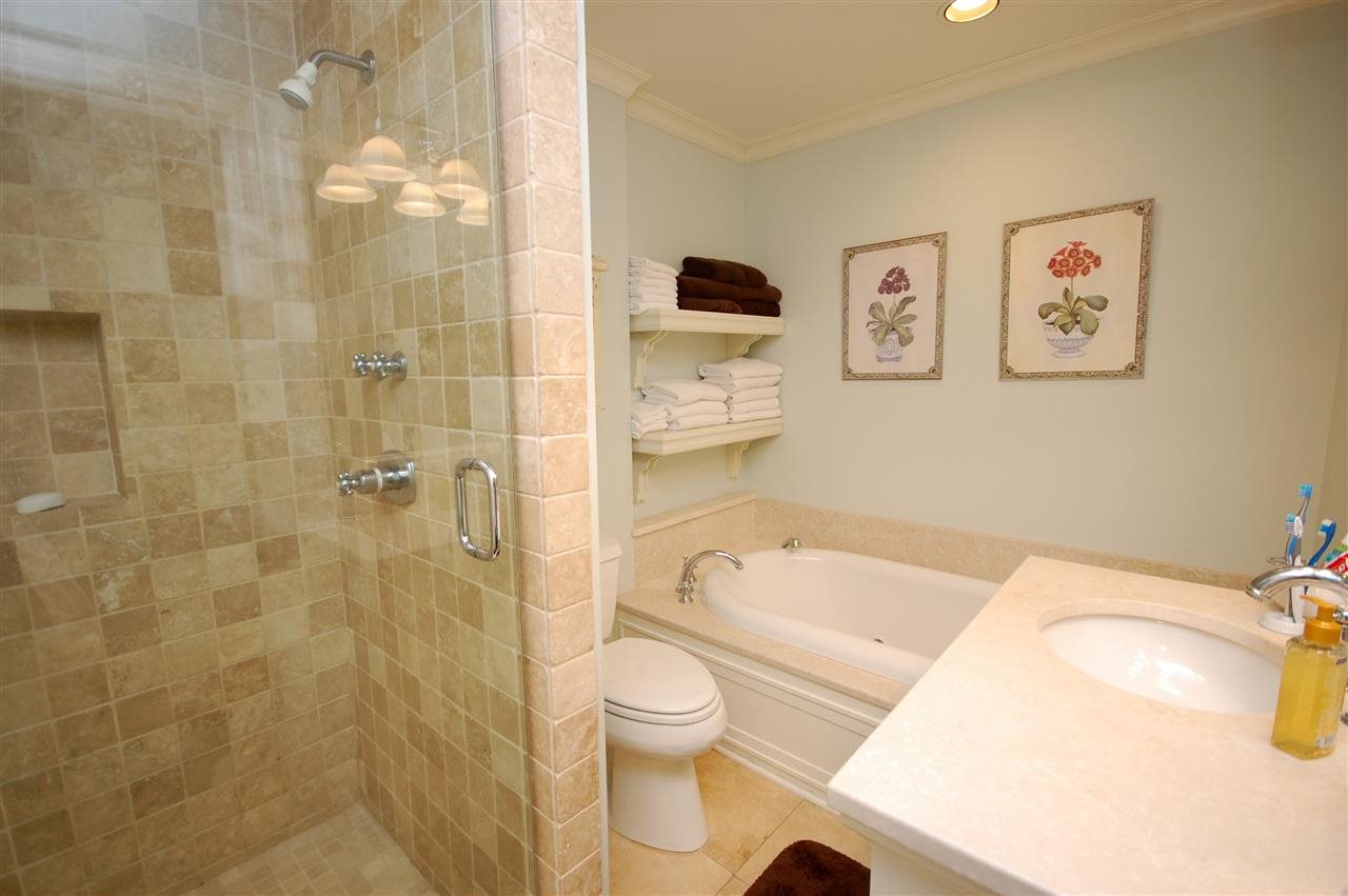 628 Kinsman Road Memphis, TN 38120 - Photo 15 of 24 Opulent master bathroom with two sinks and a large whirlpool tub and shower!