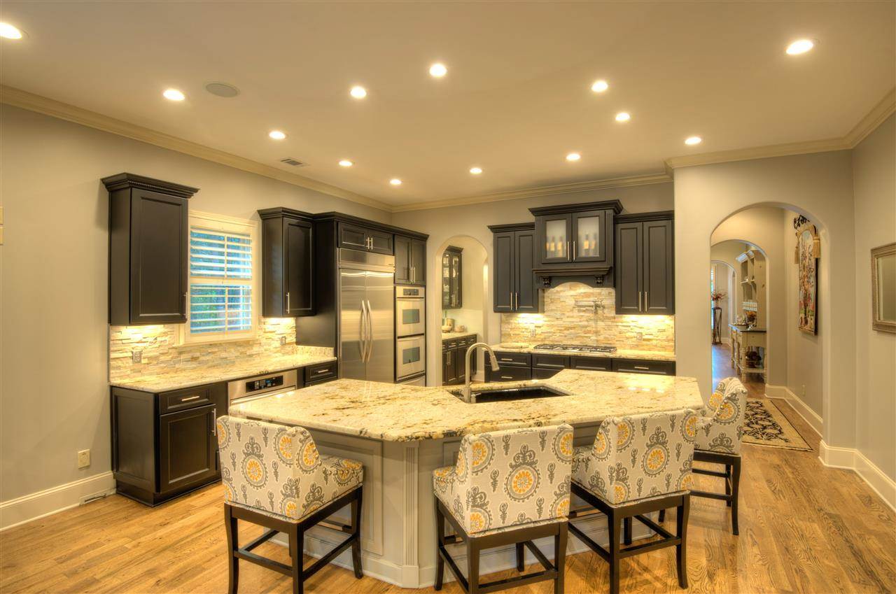 1277 South Dubray Place Collierville, TN 38017 - Photo 6 of 25 Light and bright renovated kitchen has tons of counter space for preparing meals along with inviting breakfast bar that can easily accommodate large crowds.