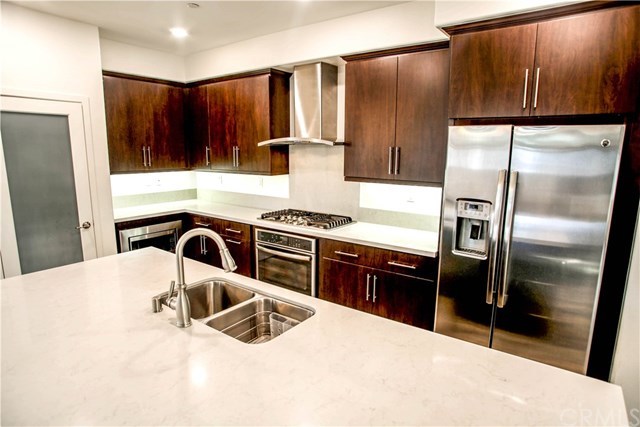 112 Acamar Irvine, CA 92618 - Photo 4 of 14 Dark Wood Cabinetry and Stainless Steel Appliances