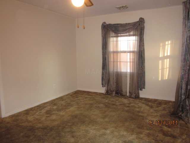 4094 Vaughn Road Memphis, TN 38122 - Photo 2 of 12 Living Room, not sure but I belive there is hardwood under the carpet.