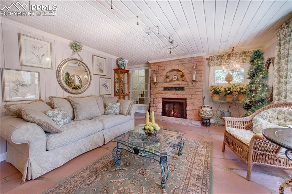 7955 Highway 24 Cascade, CO 80809 - Photo 18 of 36 Lower level living room offers flagstone flooring and Lyons flagstone Heatilator fireplace.
