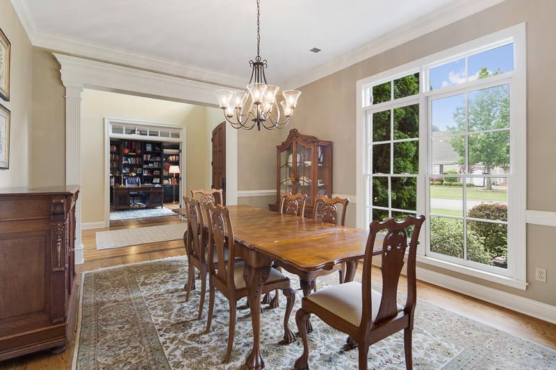 Stately dining room with large windows is fitting for elegant dinners.
