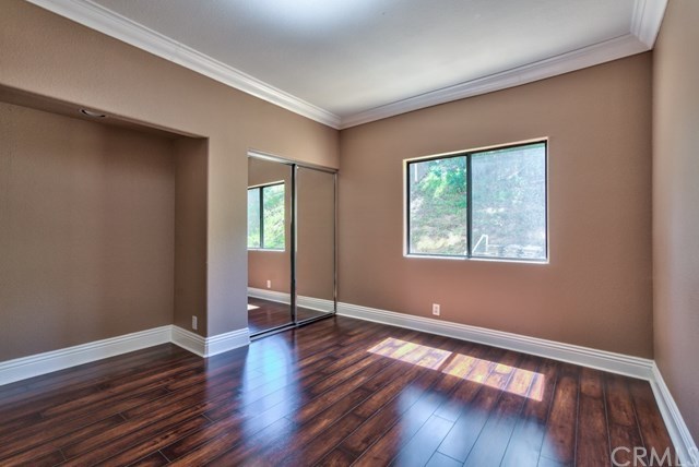 3086 Diamondview Circle Corona, CA 92882 - Photo 35 of 66 The downstairs bedroom/office is equipped with new wood floors, crown moldings and oversized baseboards.