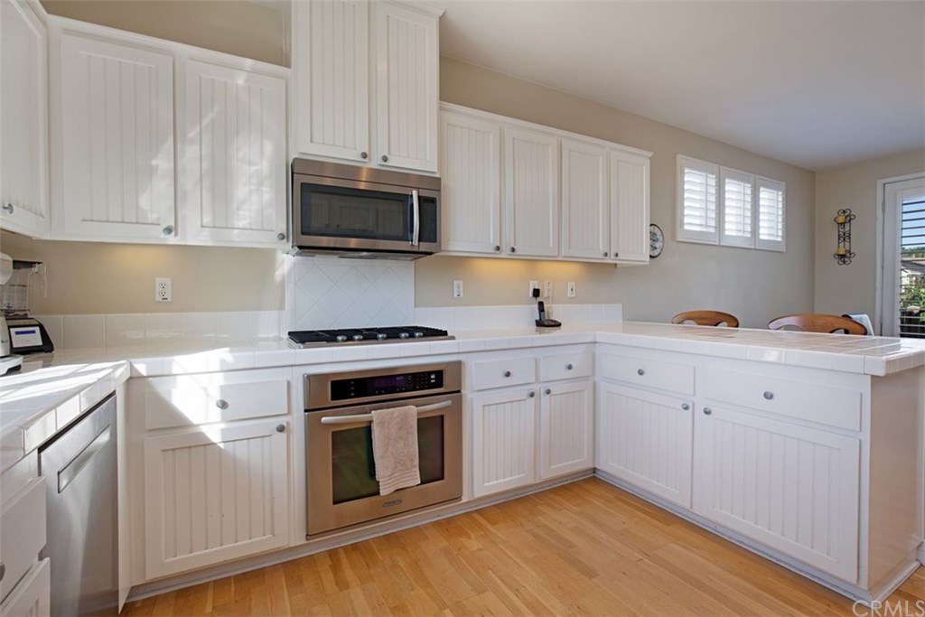 605 Corte Calmo San Clemente, CA 92673 - Photo 10 of 27 Kitchen with newer stainless steel appliances.