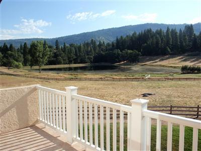 43889 Todd Eymann Road Miramonte, CA 93641 - Photo 17 of 20 Upstairs balcony with view overlooking the lake and the Sierra Nevada Mountains.