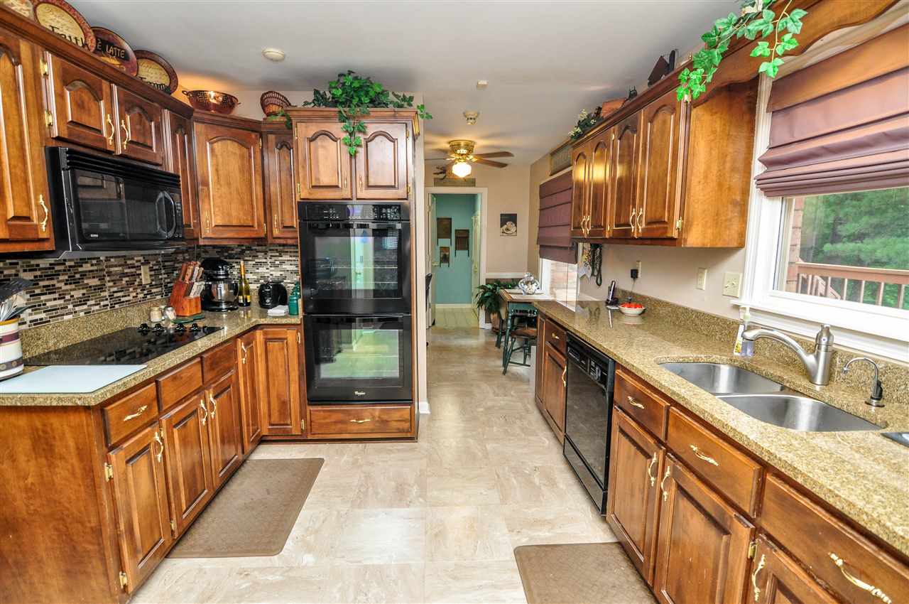 The spacious kitchen has been updated with granite countertops, tiled backsplash, tile floor, pantry, and tons of cabinet space.