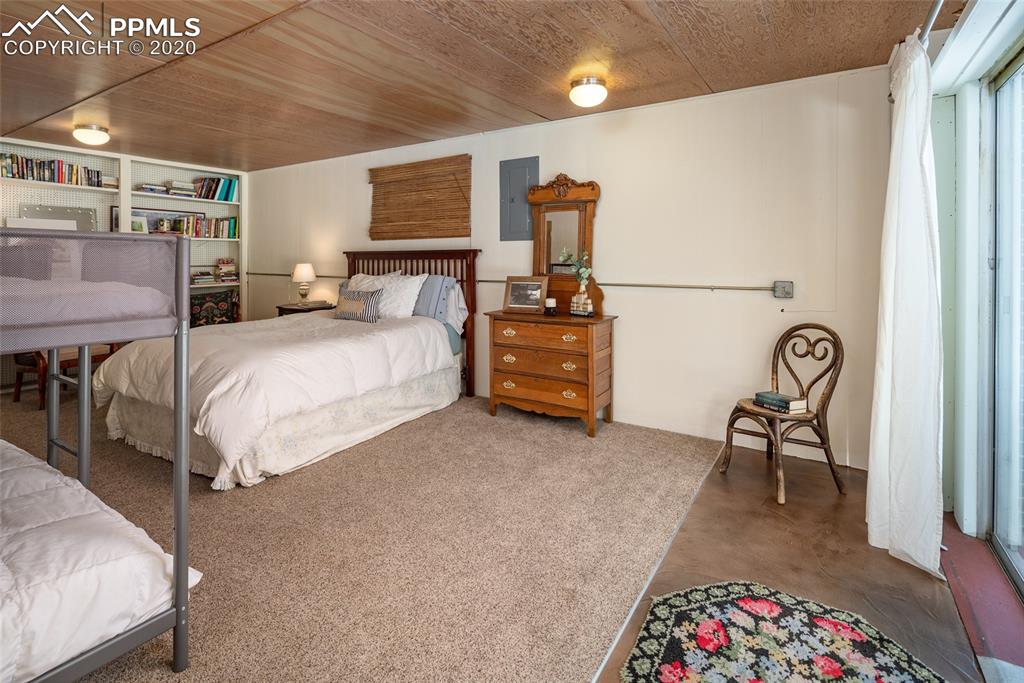 8715 Chipita Park Road Cascade, CO 80809 - Photo 28 of 33 Large 3rd bedroom or could be a family room. Built-in bookcases and storage or closet space.