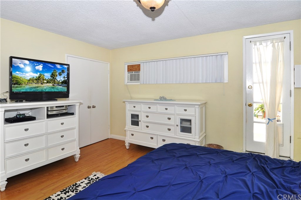 253 17th Street Seal Beach, CA 90740 - Photo 27 of 36 Another angle of this lovely bedroom, the two door closet and side deck door.