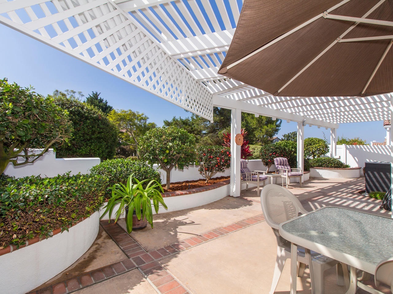 6047 Piros Way Oceanside, CA 92056 - Photo 20 of 25 Your private covered patio has beautiful views of the common area greenery located behind the home.