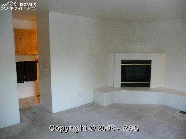 504 West Cheyenne Road Colorado Springs, CO 80906 - Photo 7 of 12 Main level master with built in firplace