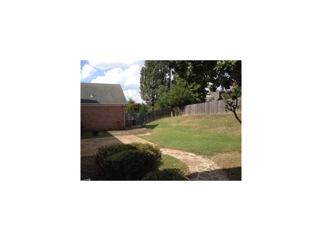 8742 Raspberry Lane Memphis, TN 38016 - Photo 23 of 23 Fenced in backyard with a custom built dog house that your pet will love.