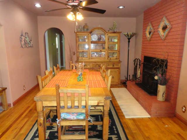 8487 Russell Road Nashville, TN 37221 - Photo 10 of 30 Original fireplace with a Buck stove and lots of room for a big dining room set