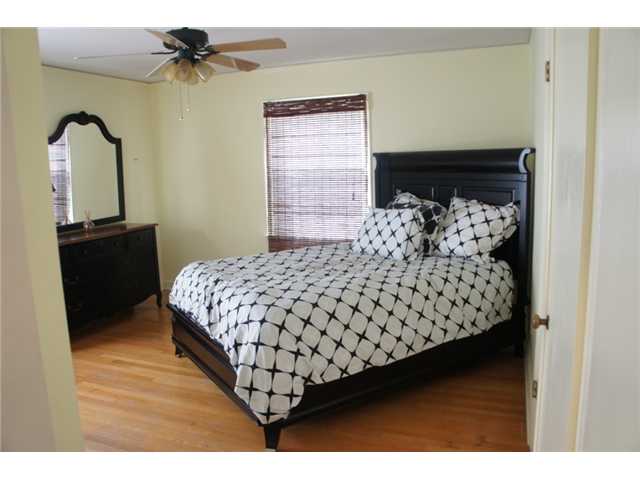 4461 Fair Meadow Road Memphis, TN 38117 - Photo 14 of 25 Fantastic master bedroom includes an updated ceiling fan, neutral colors, smooth ceiling, hardwood floors, closet, and a private bathroom.